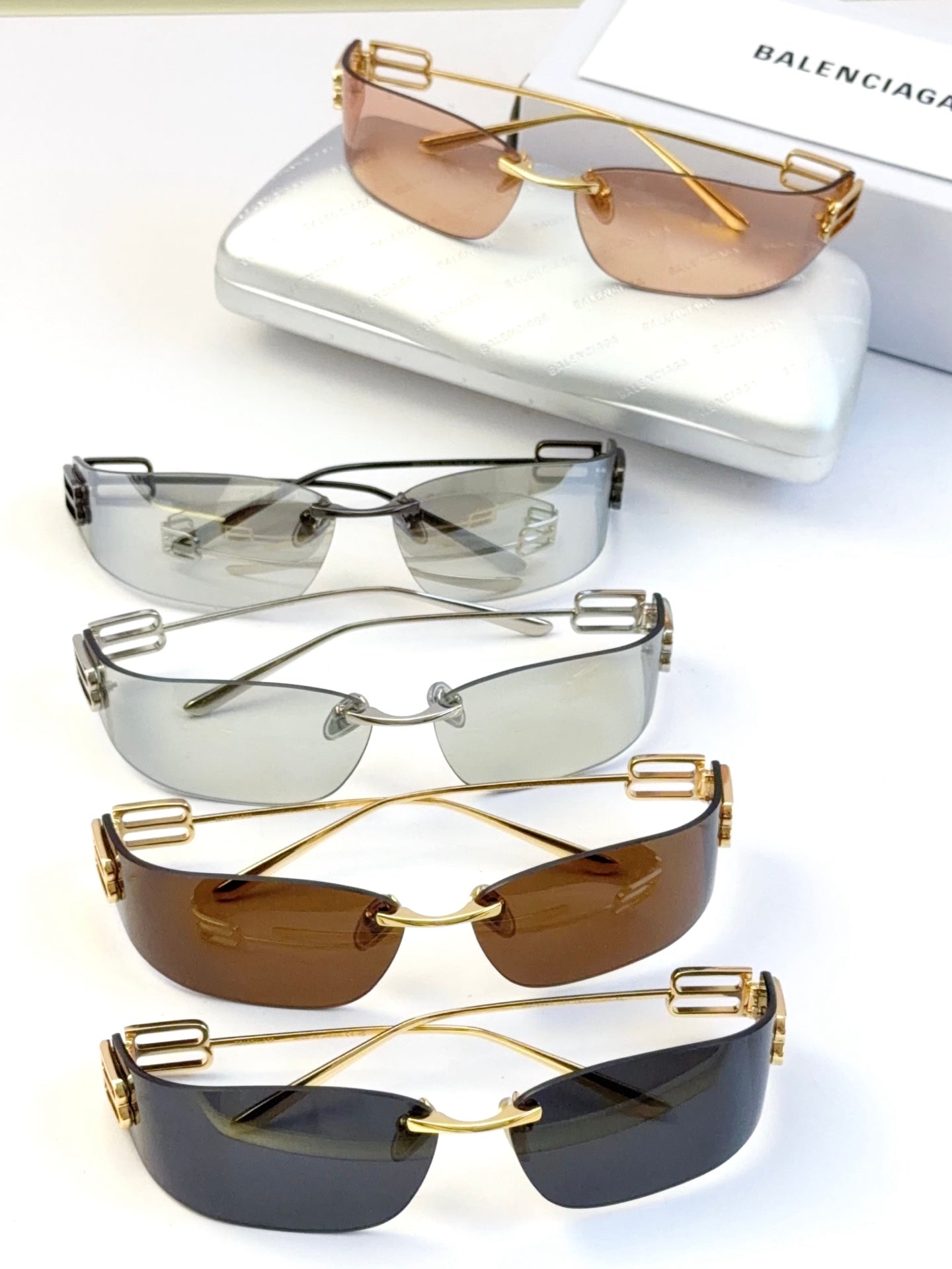 Balenciaga sunglasses set with mixed tinted lenses and metal frames, including gold and silver