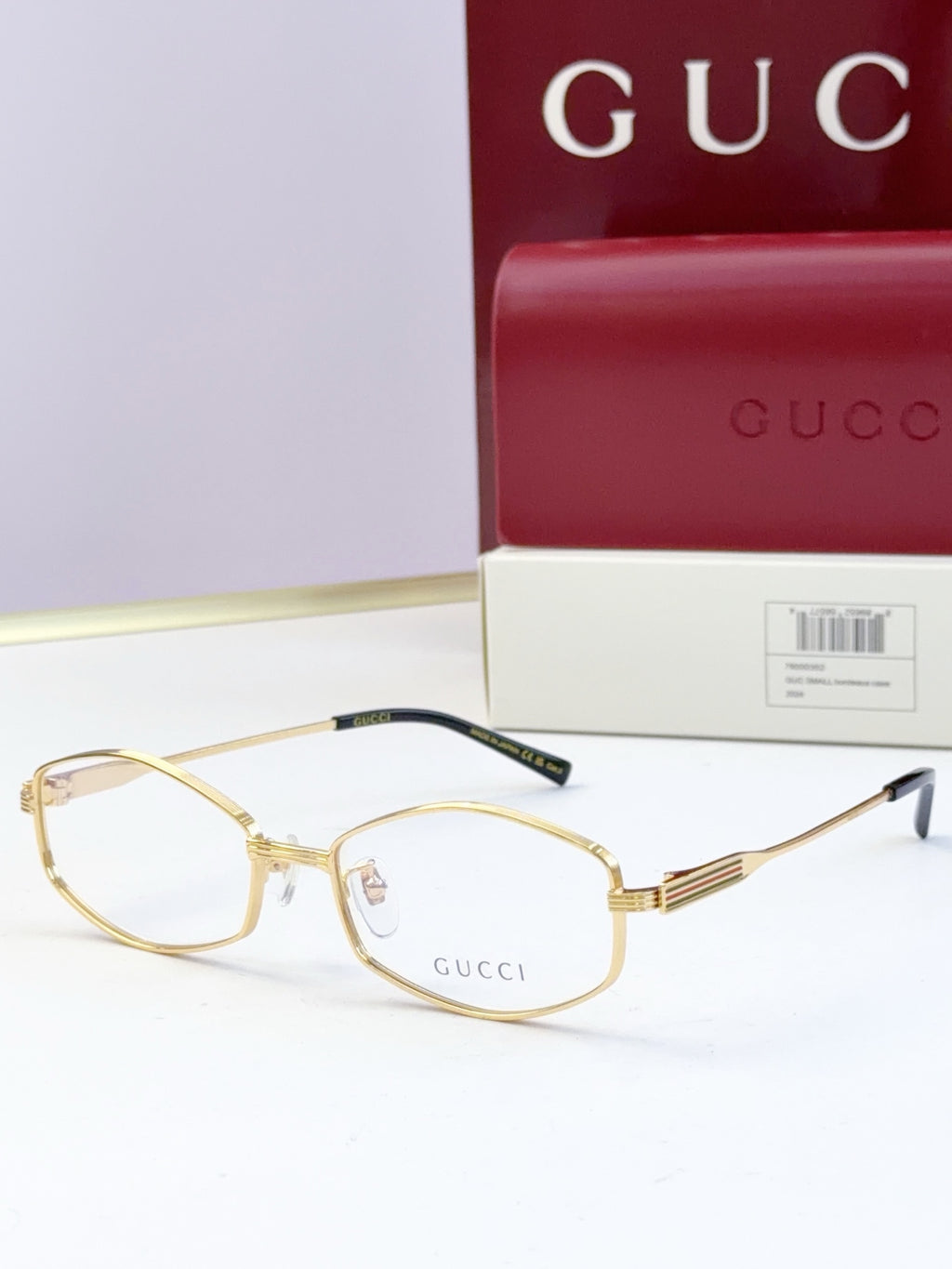 Gold full-rim glasses with clear lenses and ribbed metal temple arms