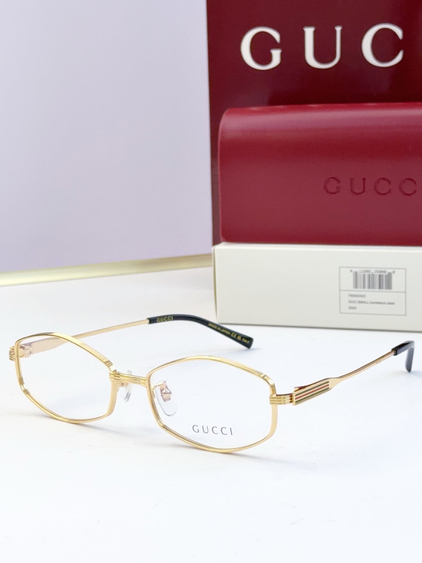 Gold full-rim glasses with clear lenses and ribbed metal temple arms