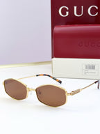 Gold glasses with brown tinted lenses and patterned temple tips