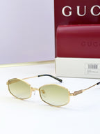 Gold full-rim glasses with light yellow tinted lenses and ribbed temple arms