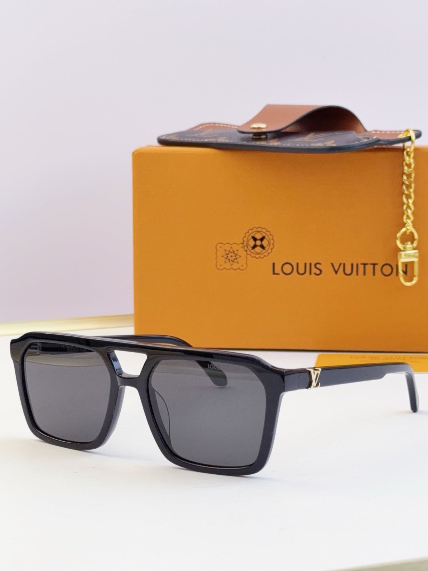 Louis Vuitton square sunglasses with dark lenses and black frame