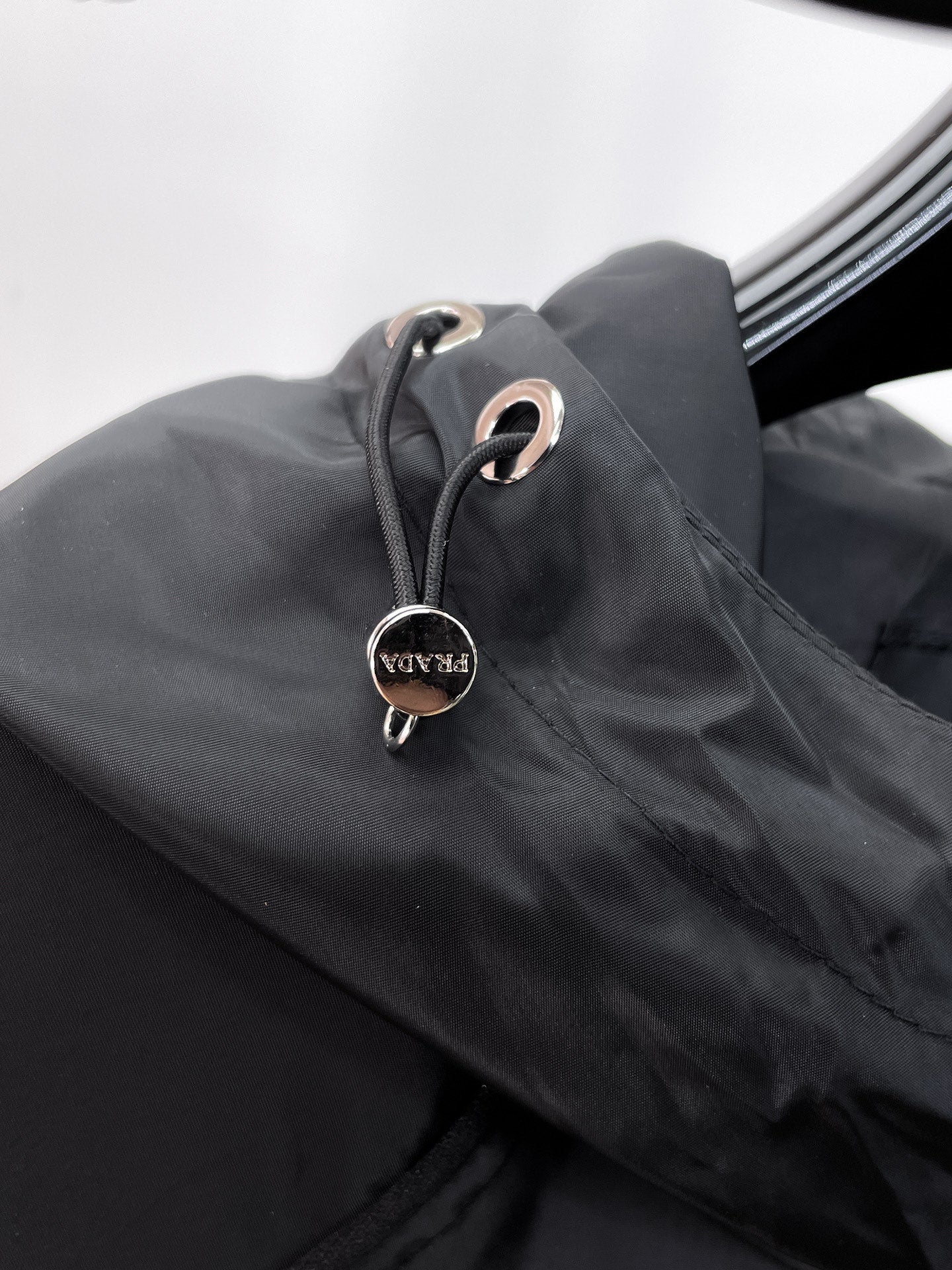 Long hood jacket toggle and drawstring detail in dark gray with metal ring hardware