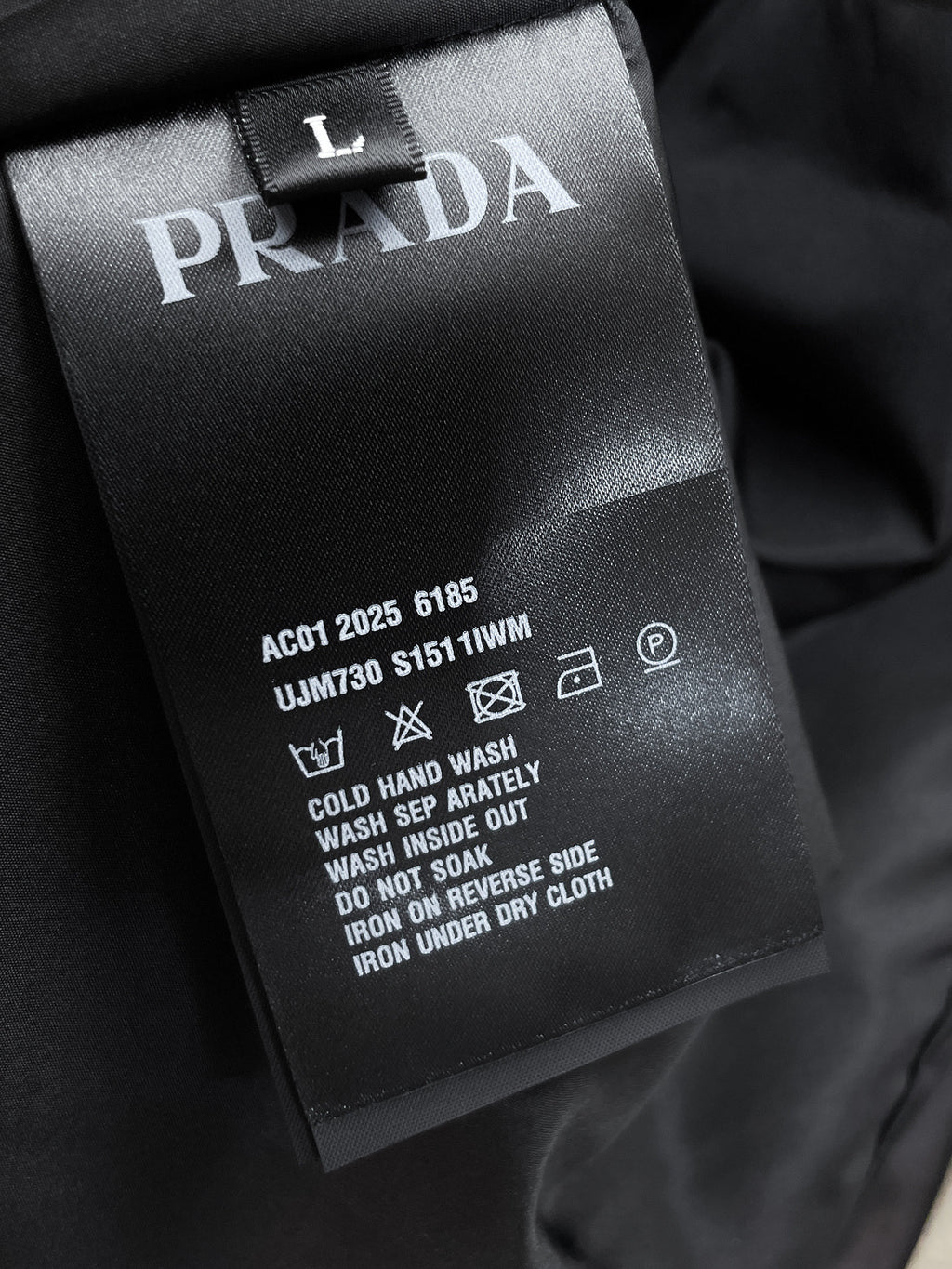 Long jacket care label with PRADA branding and washing instructions