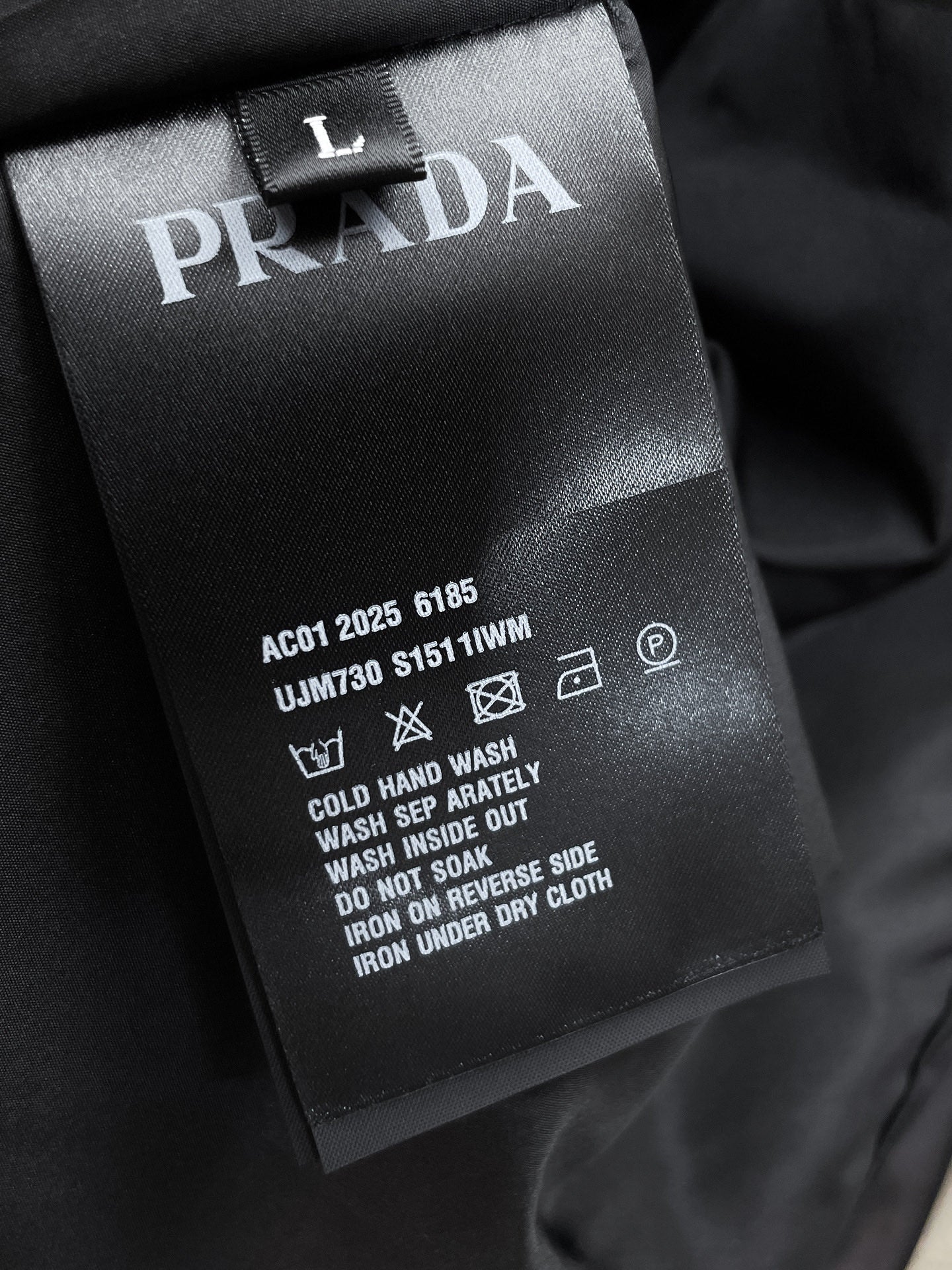 Long jacket care label with PRADA branding and washing instructions