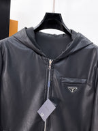 Dark hooded zip jacket with Prada chest logo patch and front zipper
