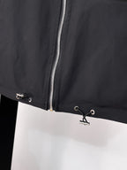 Black long jacket front with silver zipper and eyelet drawstring hem
