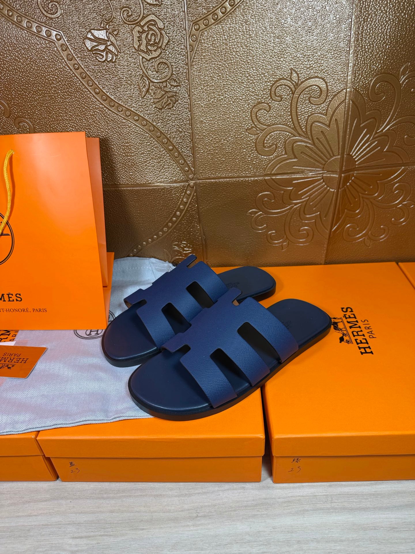 Dark blue slide sandals with open toe and three wide strap segments