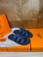 Dark blue slide sandals with thick band straps and open-toe design