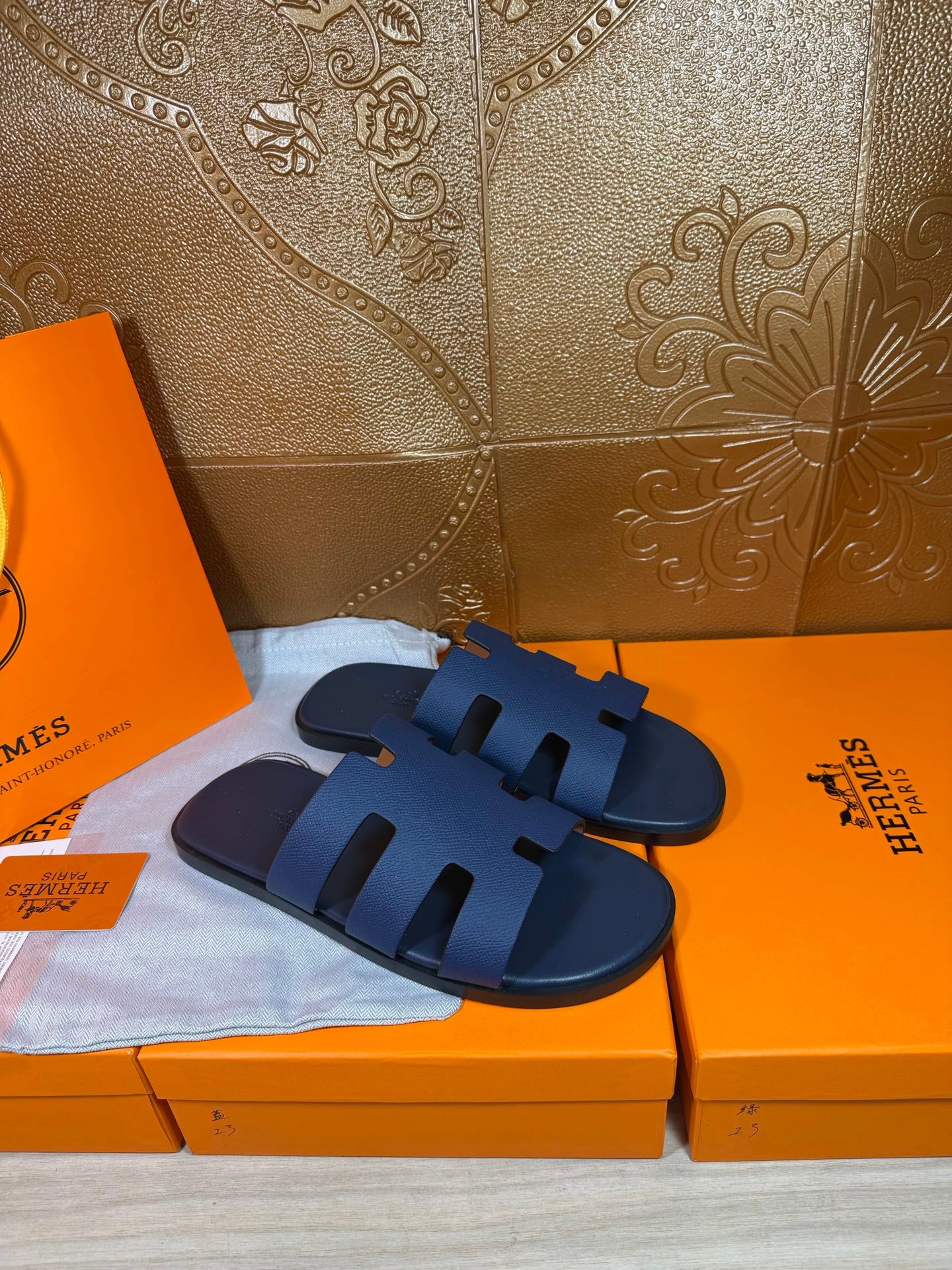 Dark blue slide sandals with thick band straps and open-toe design