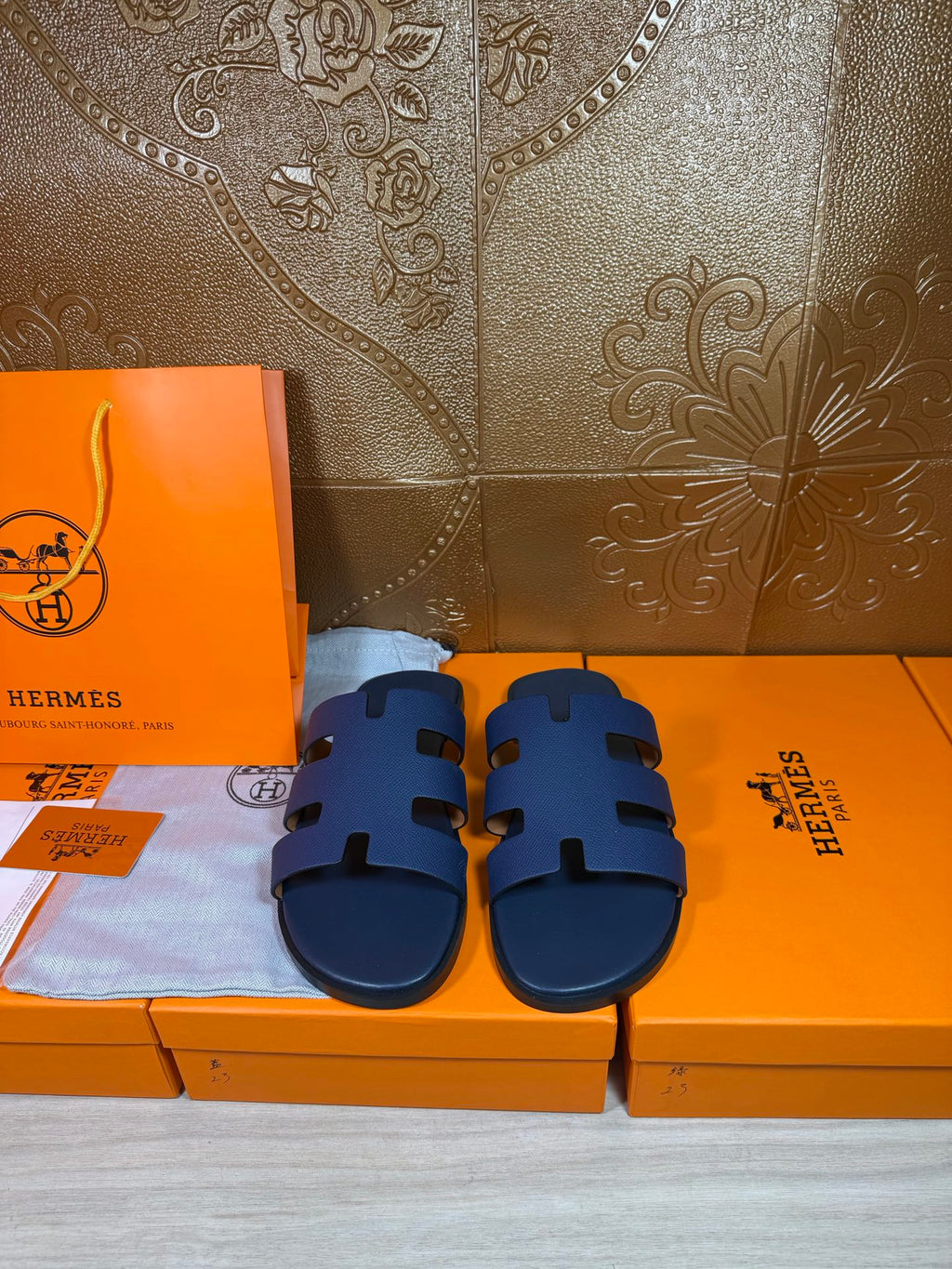 Hermes dark blue slide sandals with wide strap and cutout detailing