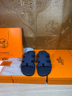 Hermes dark blue slide sandals with wide strap and cutout detailing