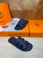 Dark blue slide sandal with thick straps and textured footbed panel