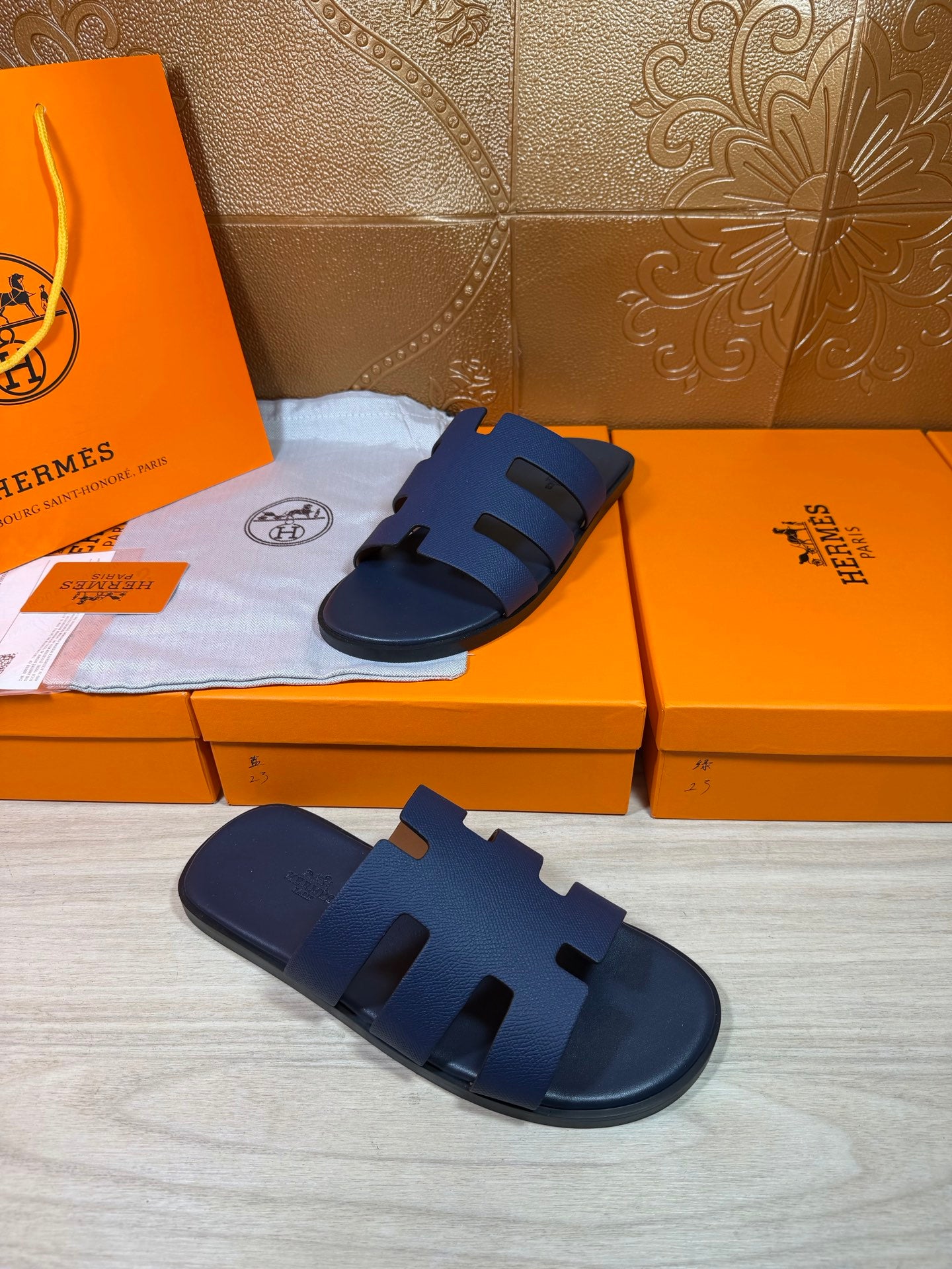 Dark blue slide sandal with thick straps and textured footbed panel