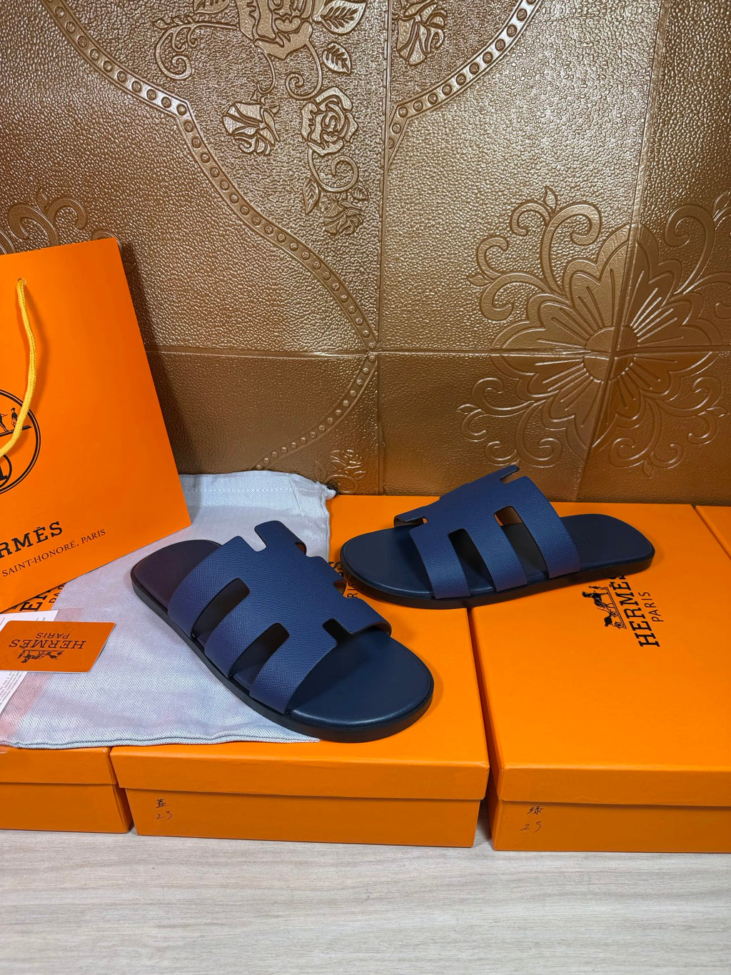 Dark blue slide sandals side by side, open toe with wide strap bands