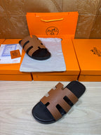 Brown leather slide sandal on dark footbed with three wide strap bands