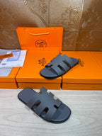 Hermes slide sandals in dark blue, front view with multiple cutout strap sections
