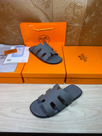 Hermes slide sandals in dark blue with open toe and stacked strap design