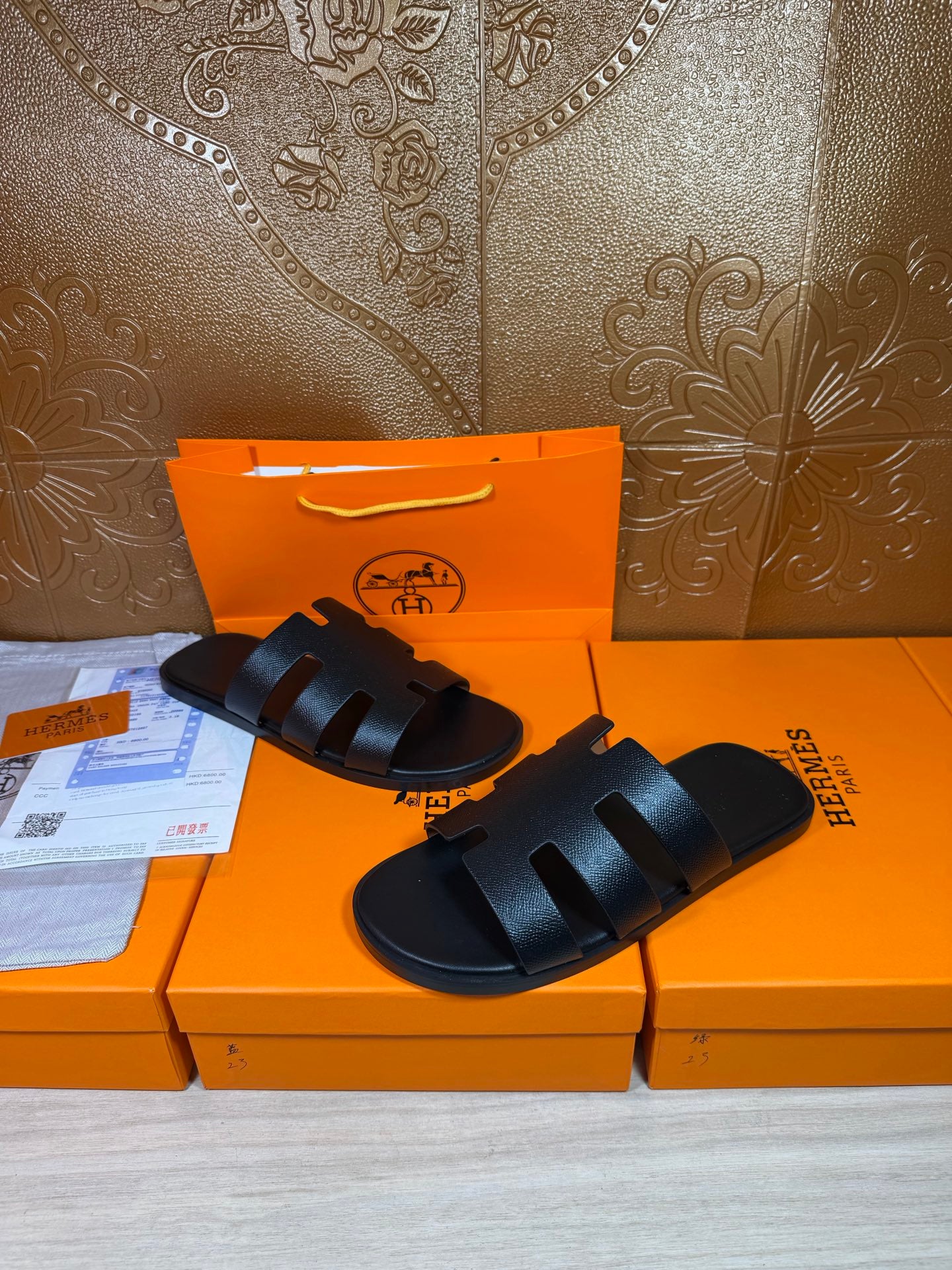 Black slide sandals with thick wide straps and open toe, stacked strap design
