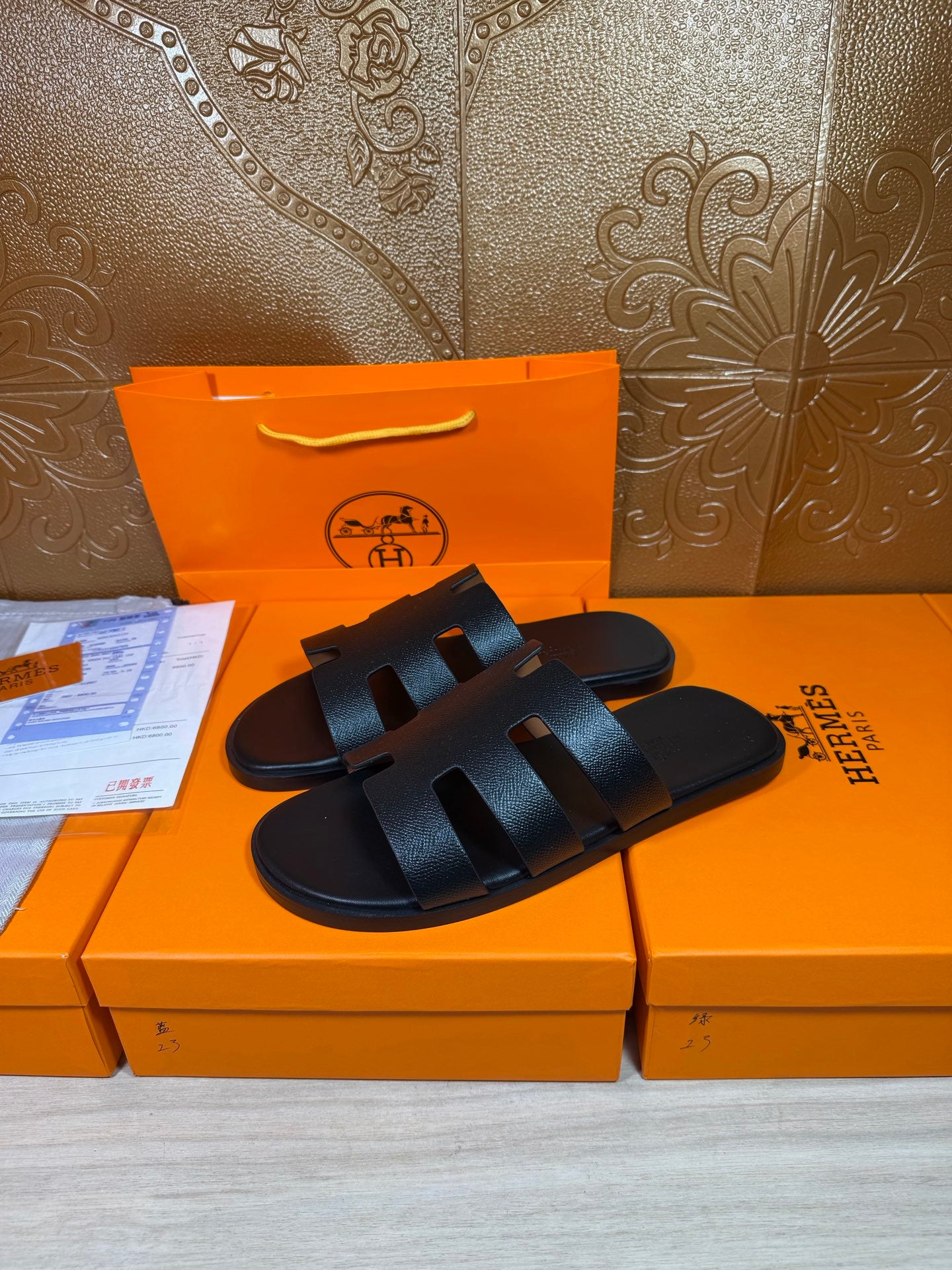 Black slide sandals, wide geometric straps with cutout details and open toe