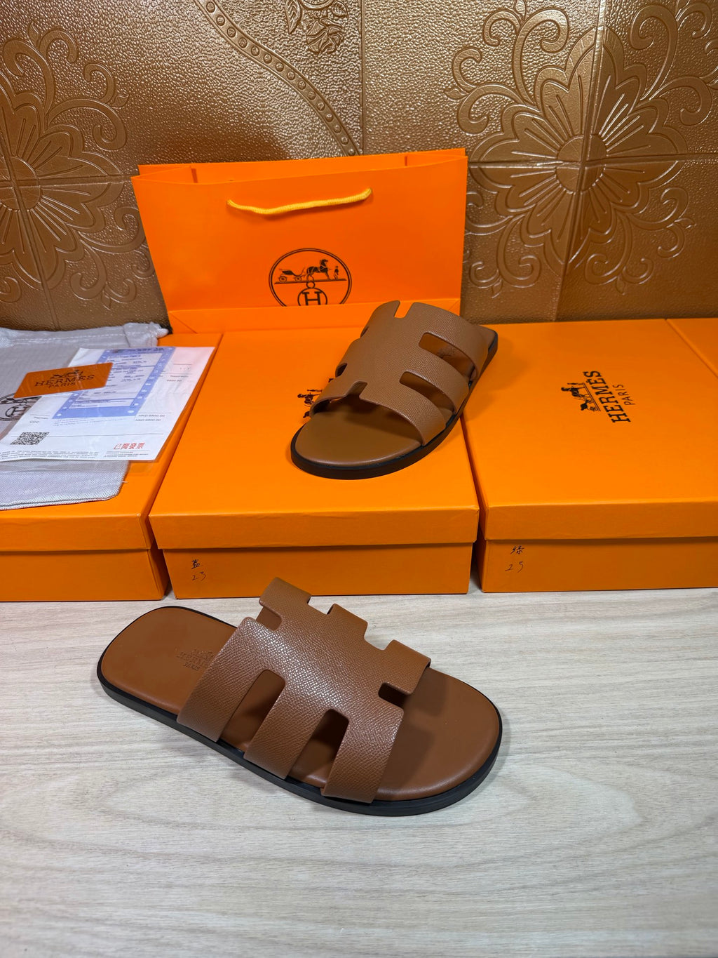 Brown slide sandal with three wide cutout straps and textured leather footbed.