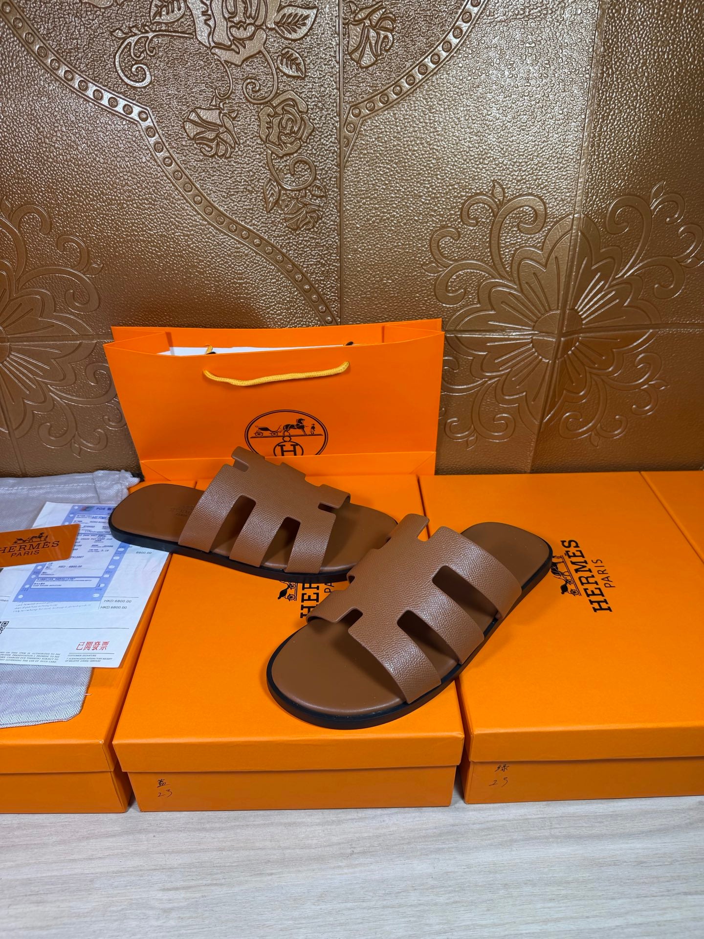 Brown slide sandals with three wide cutout straps and dark molded sole, flat fit.