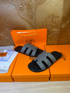 Hermes slide sandals, black with light gray segmented strap bands