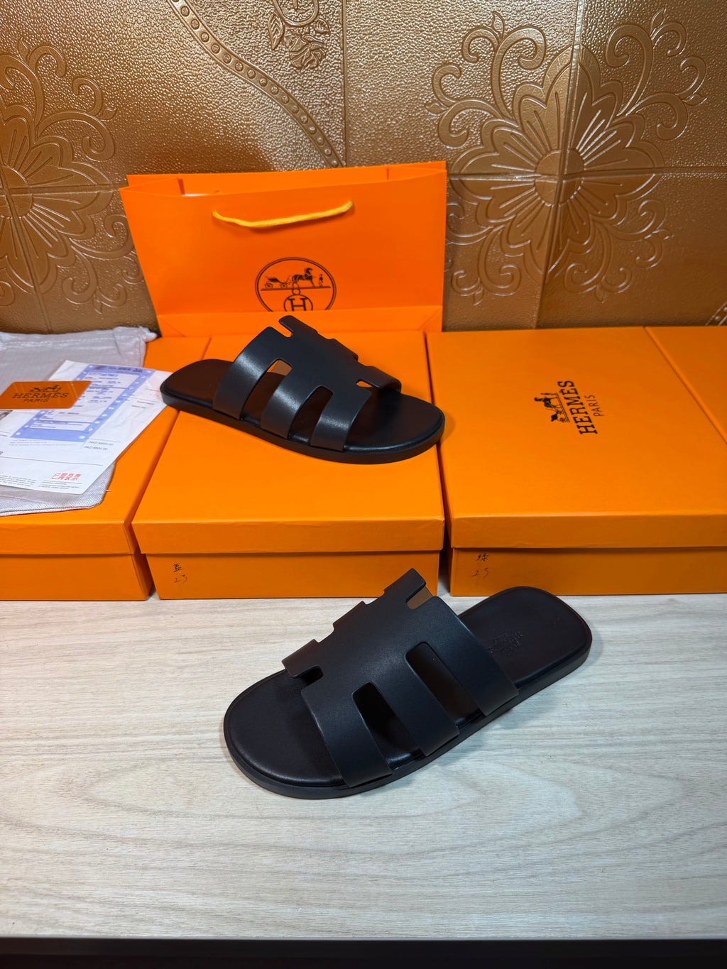 Hermes slide sandals, dark navy, front view with three strap bands per foot