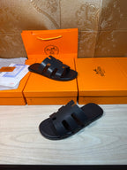 Hermes slide sandals, dark navy, front view with three strap bands per foot