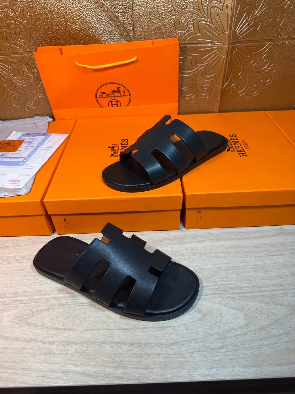 Hermes slide sandals, dark navy, side view of wide strap bands