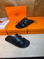 Hermes slide sandals, dark navy, side view of wide strap bands