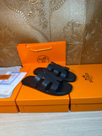 Hermes slide sandals with four wide straps, dark navy leather upper