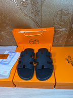 Hermes slide sandals in dark navy with wide strap detail and open toe