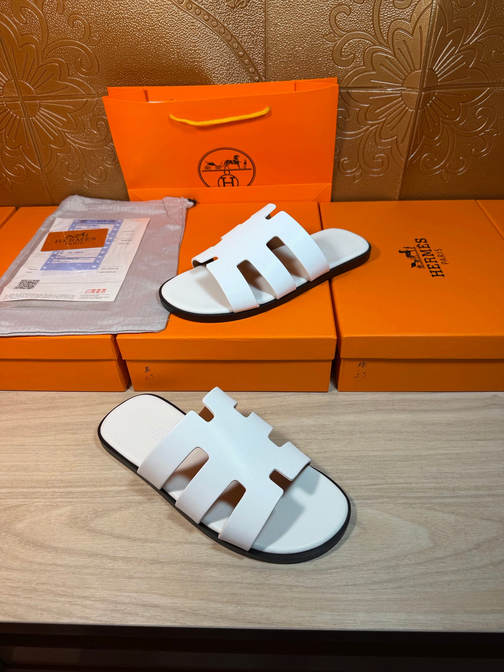 Hermes sandals with white straps and low-profile slide sole, open toe