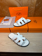 Hermes sandals with white straps and low-profile slide sole, open toe