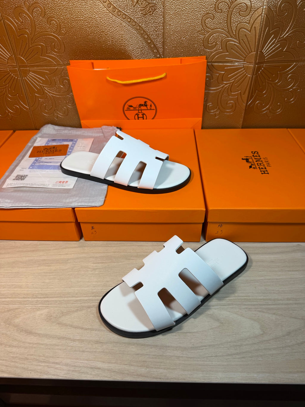 Hermes slide sandals with white straps, open toe and cushioned light sole