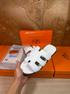 Hermes sandals with white straps and open toe, angled side view