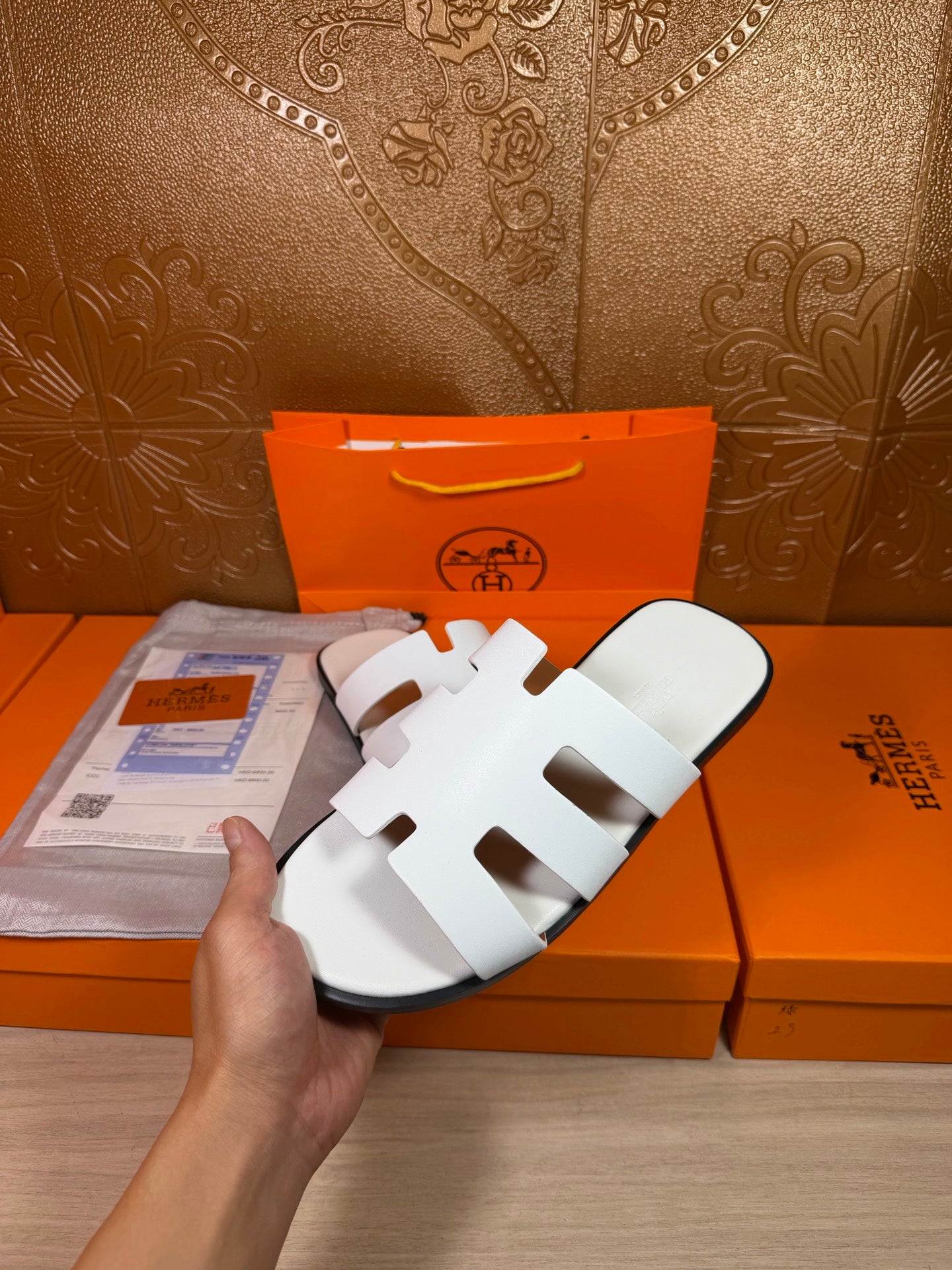 Hermes sandals with white straps and open toe, angled side view