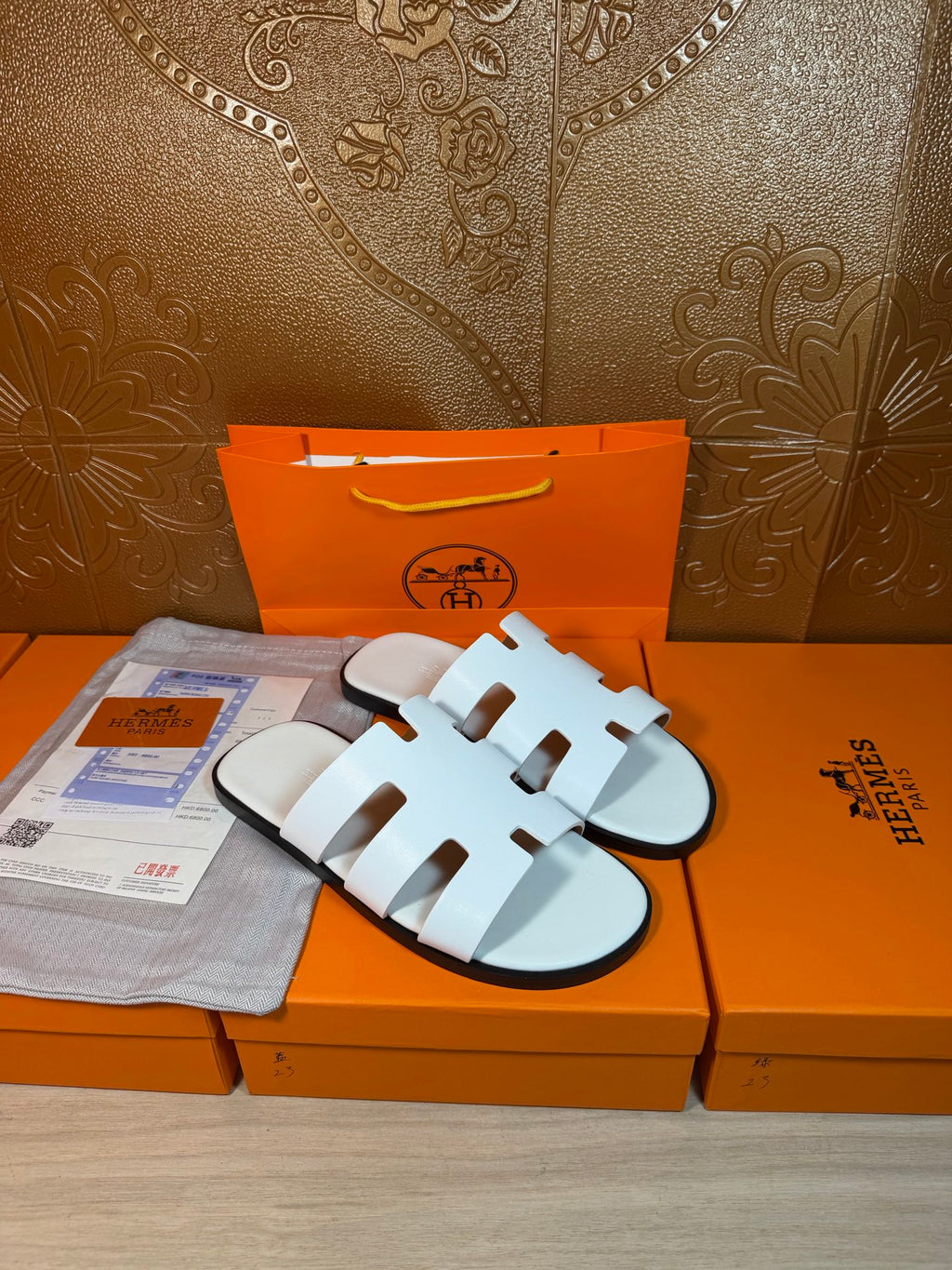 Hermes sandals with white multi-strap upper on a light sole, open toe