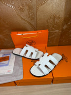 Hermes sandals with white straps and open toe, close angled view