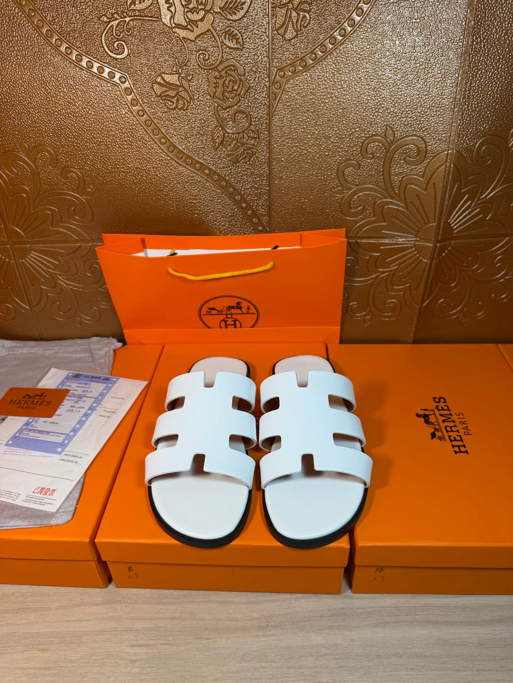 Hermes sandals with white straps and open-toe slide design