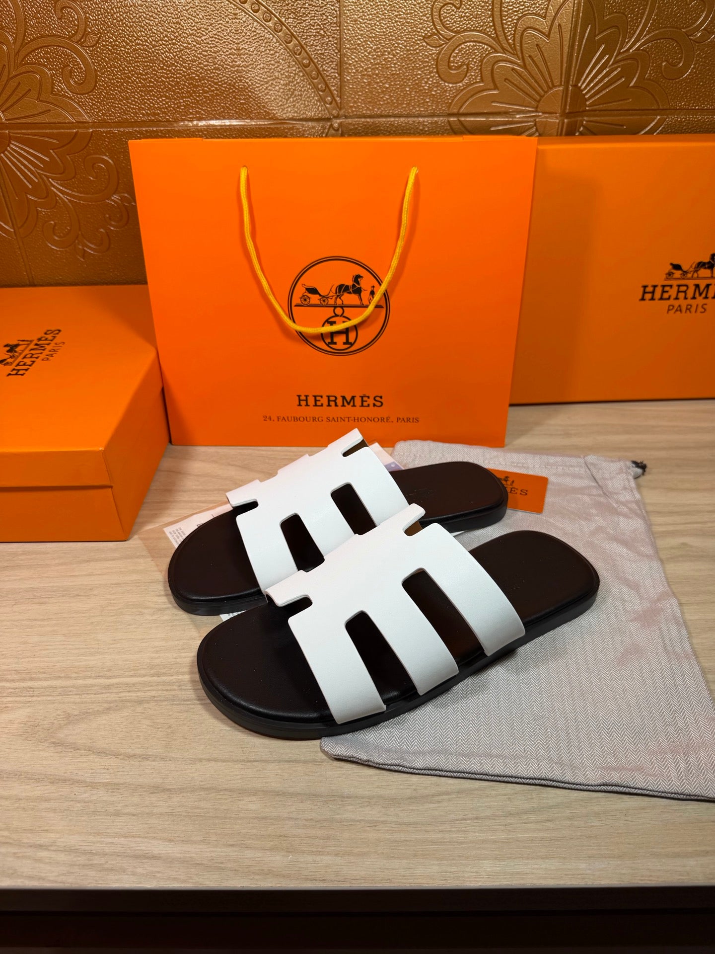 Hermes slide sandals, white straps over black cushioned footbeds