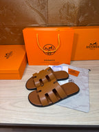 Hermes slide sandals, tan-brown leather with three cutout straps, flat sole