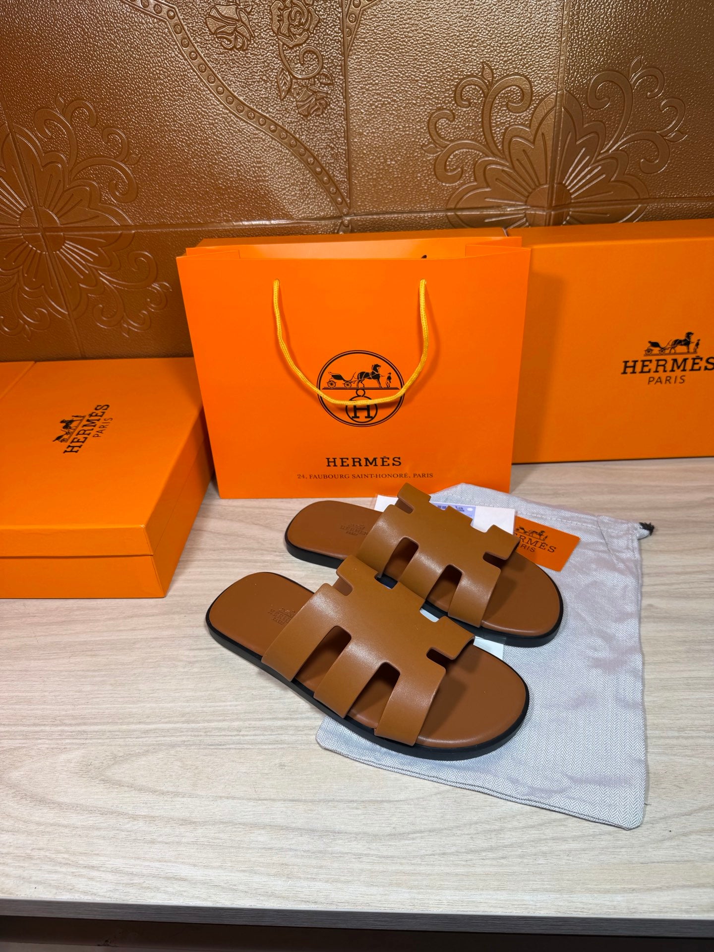 Hermes tan-brown leather slide sandals with wide cutout straps, flat sole