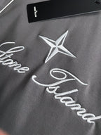 Stone Island T-shirt fabric with white star logo and cursive script embroidery