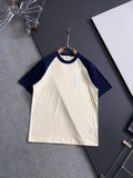 T-shirt with white body, navy raglan sleeves, and small embroidered logo on chest