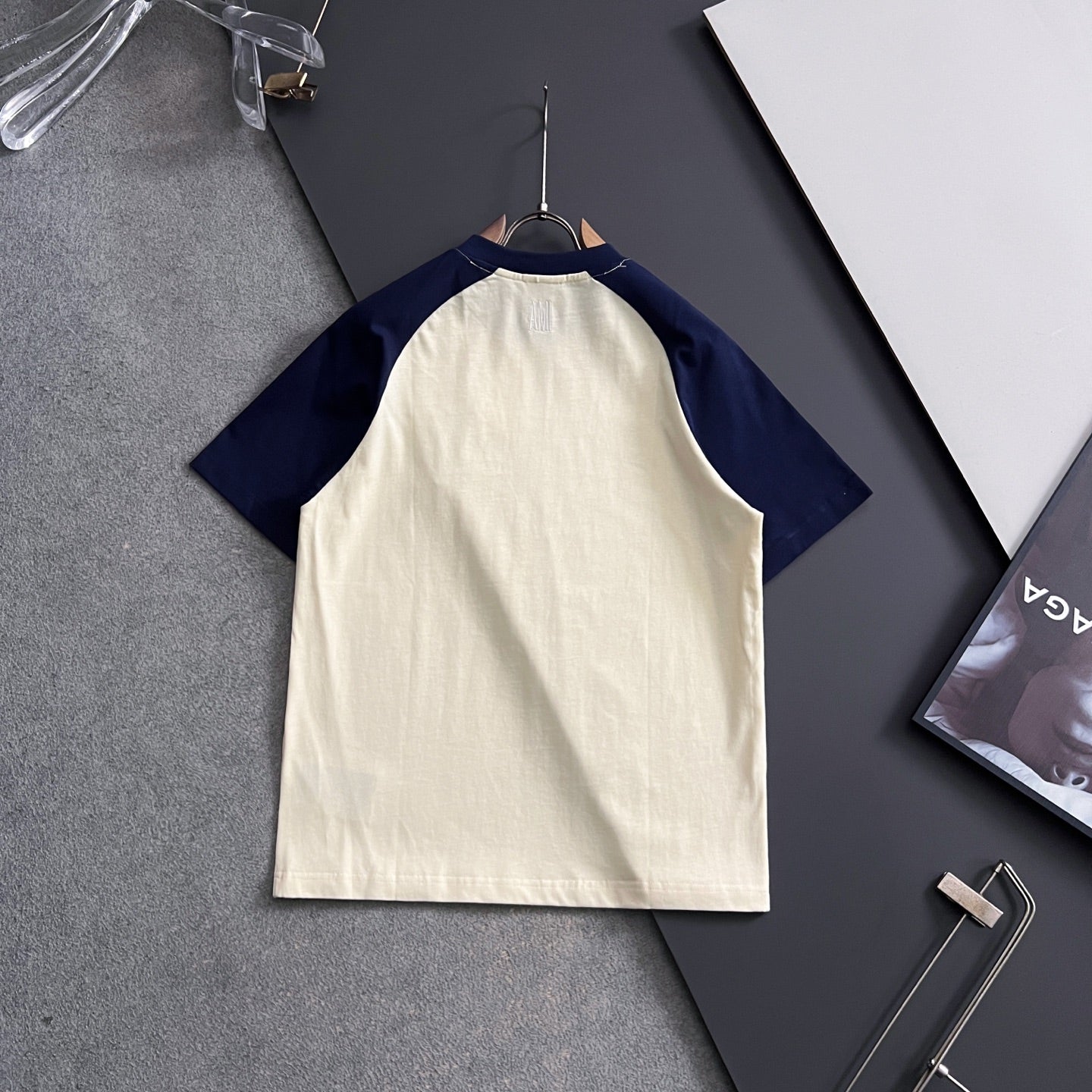 Cream T-shirt with navy raglan sleeves, no visible front graphic