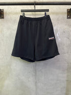 Black drawstring shorts with elastic waistband and Balenciaga side logo