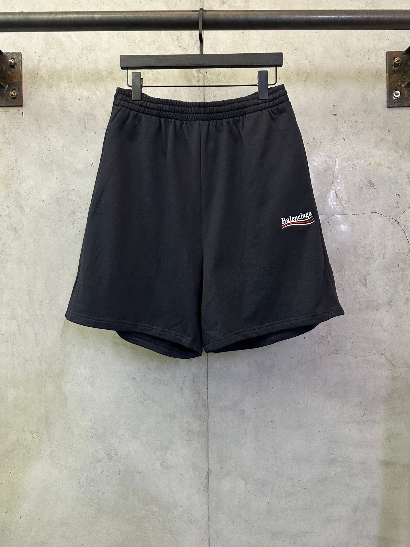 Black drawstring shorts with elastic waistband and Balenciaga side logo