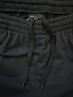 Black elastic-waist shorts with drawstring ties and Balenciaga Unisex label
